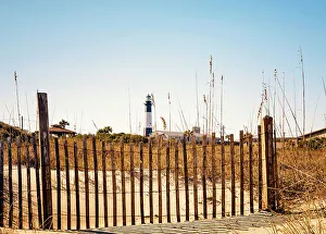 Georgia, Tybee Island, Tybee Lighthouse seen through picket fence