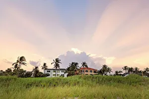 Light Prints: Houses overlooking the ocean with dramatic sky in background