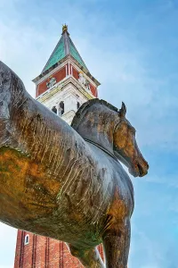 Italia Prints: Italy, Veneto, Venice, Triumphal Quadriga detail at Saint Mark's Basilica facade with Campanile di San Marco