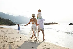 Mxico Prints: Mexico, Couple with children strolling along beach surf