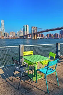Lower Manhattan Prints: New York City, Brooklyn, Colorful chairs and tables in Brooklyn Bridge Park with view of Manhattan