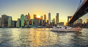 Images Dated 31st August 2018: New York City, Lower Manhattan financial district with yacht passing under Brooklyn Bridge