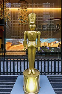 Christmastide Prints: NYC, Manhattan, Midtown, lobby, golden statue of toy soldier, Christmas
