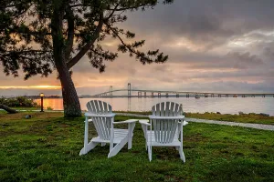 Rhode Island, Newport, adirondack chairs facing Claiborne Pell Bridge over Narragansett Bay