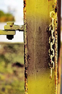 Iron Prints: Rusted yellow steel beam with chain