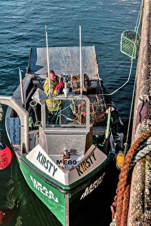 Images Dated 23rd February 2023: Scotland, Highlands, Balintore, Lobster Fishermen loading boat with traps