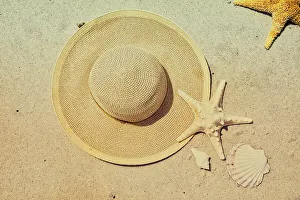 Starfish Prints: Seashells, Starfish, and hat arranged on beach