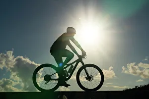 Silhouette of man riding bicycle