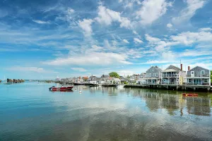 USA, Nantucket, Massachusetts, New England, shore houses, clear water, boats near to the dock, blue sky with some clouds